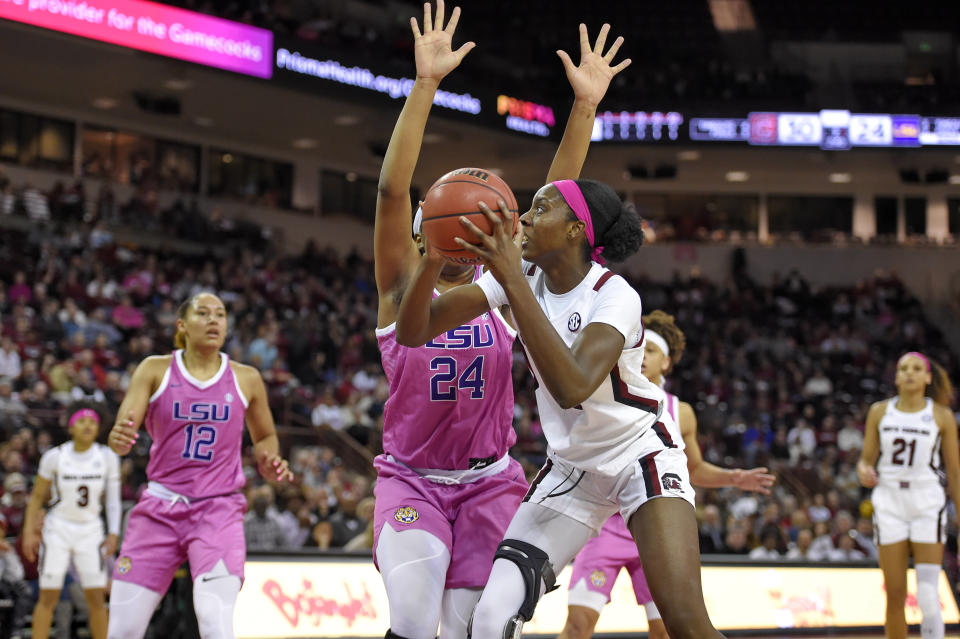 South Carolina's Victaria Saxton, front, shoots while defended by LSU's Faustine Aifuwa during the first half of an NCAA college basketball game Thursday, Feb. 20, 2020, in Columbia, S.C. (AP Photo/Richard Shiro)