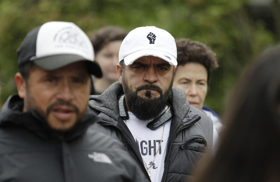 In this photo taken Wednesday, July 17, 2019, Jose Robles, center, walks with supporters before he presented himself to U.S. Immigration and Customs Enforcement officials in Tukwila, Wash. The prospect of nationwide immigration raids has provided evidence that legions of pastors, rabbis and their congregations stand ready to help vulnerable immigrants with offers of sanctuary and other services. (AP Photo/Elaine Thompson)