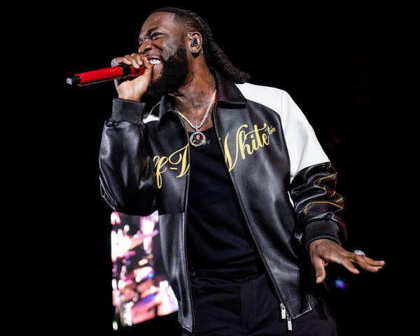 <p>Timothy Norris/Getty</p> Burna Boy performs in Los Angeles in November 2023