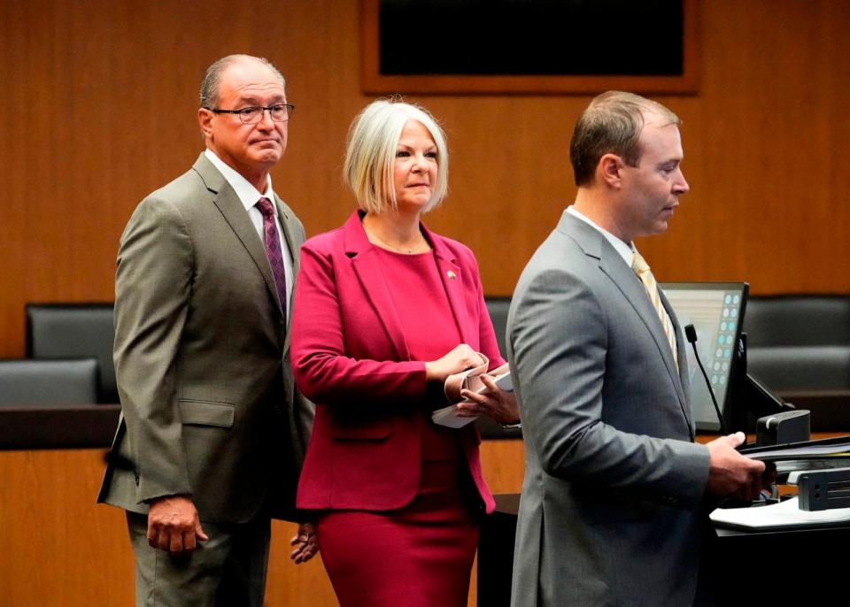 PHOTO: Former chair of the Arizona Republican Party Kelli Ward (C) and her husband Michael Ward (L) appear with their attorney (right) for their arraignment in Maricopa County Superior Court in Phoenix, Arizona on May 21, 2024. (Rob Schumacher/POOL/AFP via Getty Images)