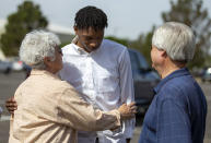 Former New Mexico State NCAA college basketball player Deuce Benjamin, center, receives the support of his fans upon his arrival to a news conference in Las Cruces, N.M., Wednesday, May 3, 2023. Benjamin and former Aggie player Shak Odunewu discussed the lawsuit they filed alleging teammates ganged up and sexually assaulted them multiple times, while their coaches and others at the school didn't act when confronted with the allegations. (AP Photo/Andres Leighton)