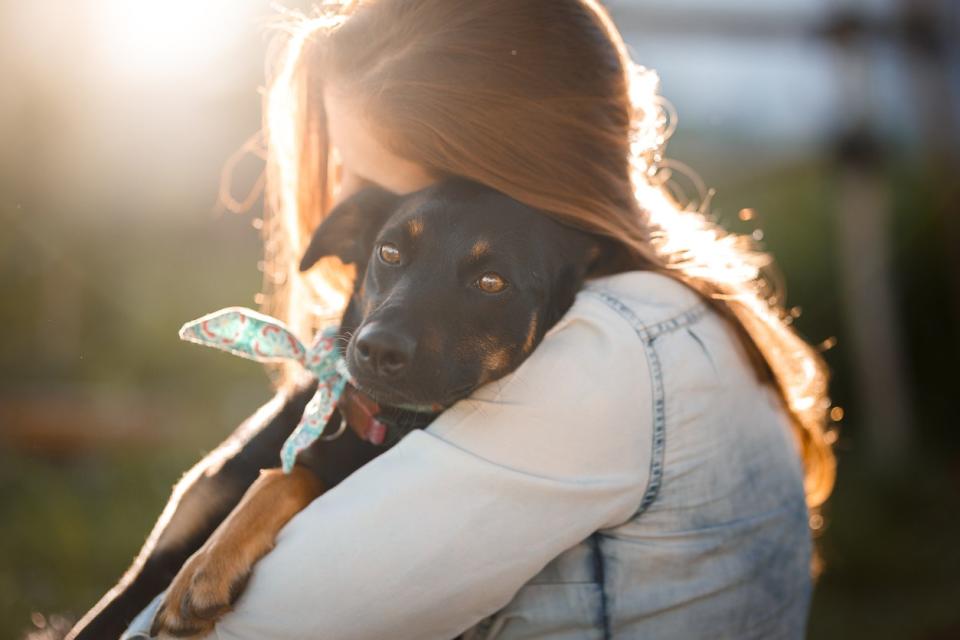 girl hugging dog