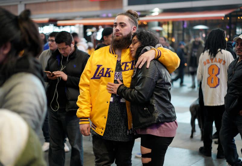 Mourners gather in Microsoft Square near the Staples Center to pay respects to Kobe Bryant after a helicopter crash killed the retired basketball star, in Los Angeles