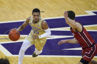 Washington guard Quade Green (55) drives around Utah guard Pelle Larsson, right, during the first half of an NCAA college basketball game, Sunday, Jan. 24, 2021, in Seattle. (AP Photo/Ted S. Warren)