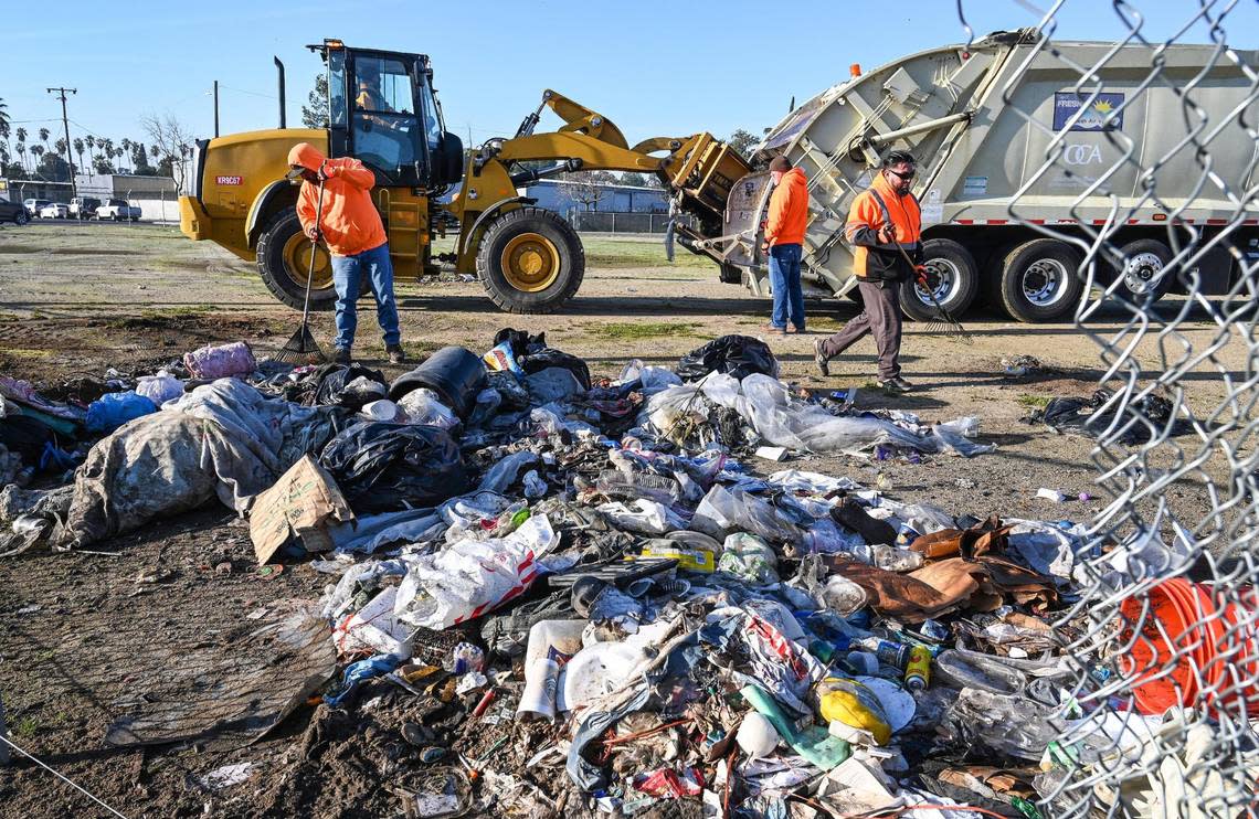 A crew with Fresno’s Homeless Assistance Response Team (HART) begins a homeless camp cleanup operation behind several shelters on Parkway Drive in Fresno on Wednesday, Feb. 1, 2023