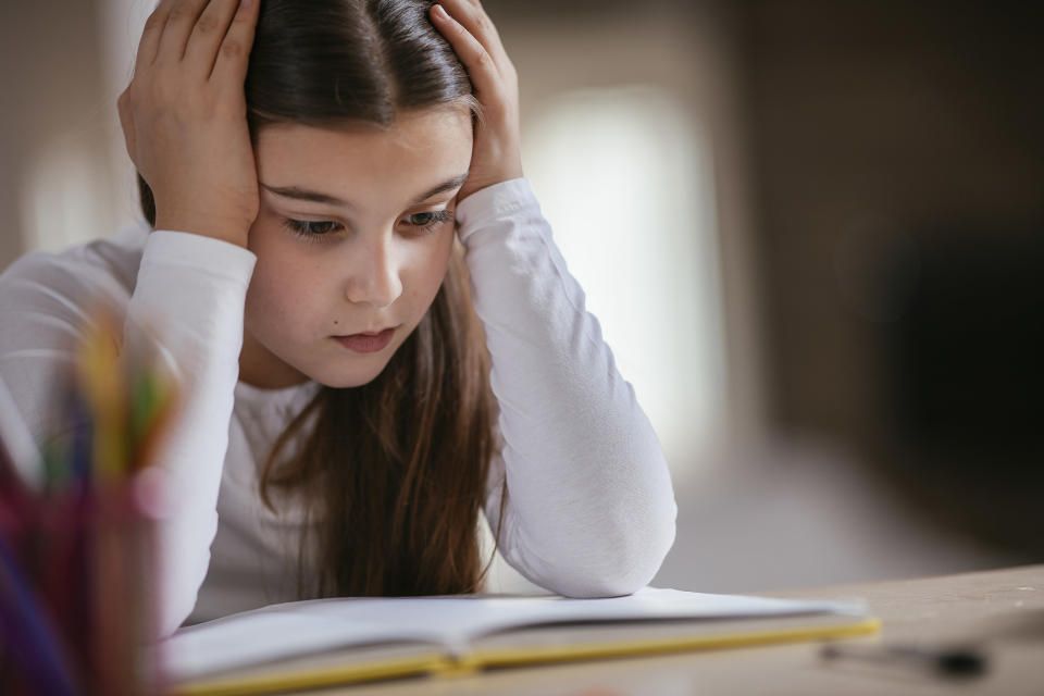 young girl struggling with her homework