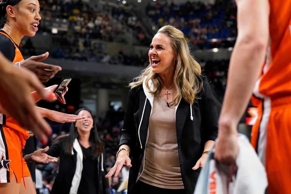 Team Wilson head coach Becky Hammon talks to players during the first half of a WNBA All-Star basketball game against the Team Stewart in Chicago, Sunday, July 10, 2022.