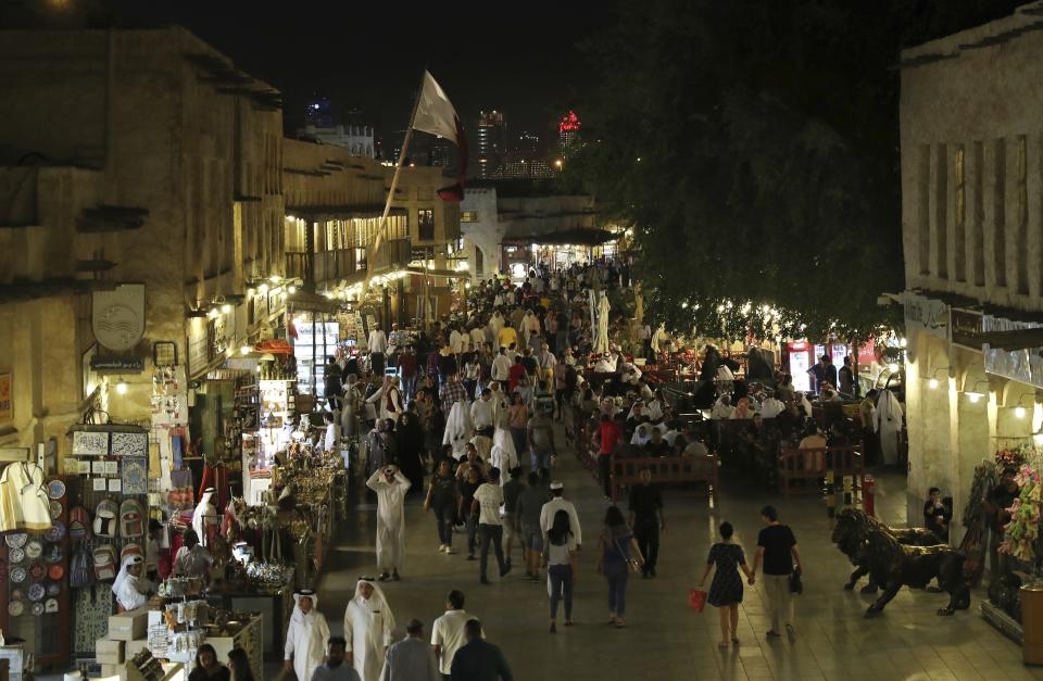 FILE - In this Monday, May 13, 2019 file photo, people walk at Souq Waqif in Doha, Qatar. Qataris awoke to a surprise blockade and boycott by Gulf Arab neighbors 3 1/2 years ago, and this week were jolted again by the sudden announcement that it was all over. (AP Photo/Kamran Jebreili, File)