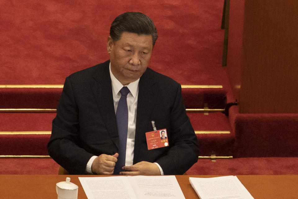 In this photo taken Friday, May 22, 2020, Chinese President Xi Jinping attends the opening session of the National People's Congress held at the Great Hall of the People in Beijing. China is taking matters into its own hands after last year’s tumultuous anti-government protests in Hong Kong that often descended into tear gas-filled clashes. (AP Photo/Ng Han Guan)