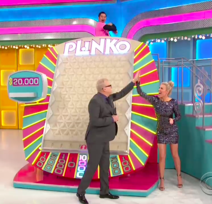 Drew Carey and Rachel Reynolds high-five while the contestant celebrates after landing on $10,000 twice in a row in Plinko on <em>The Price Is Right</em>. (Photo: CBS)