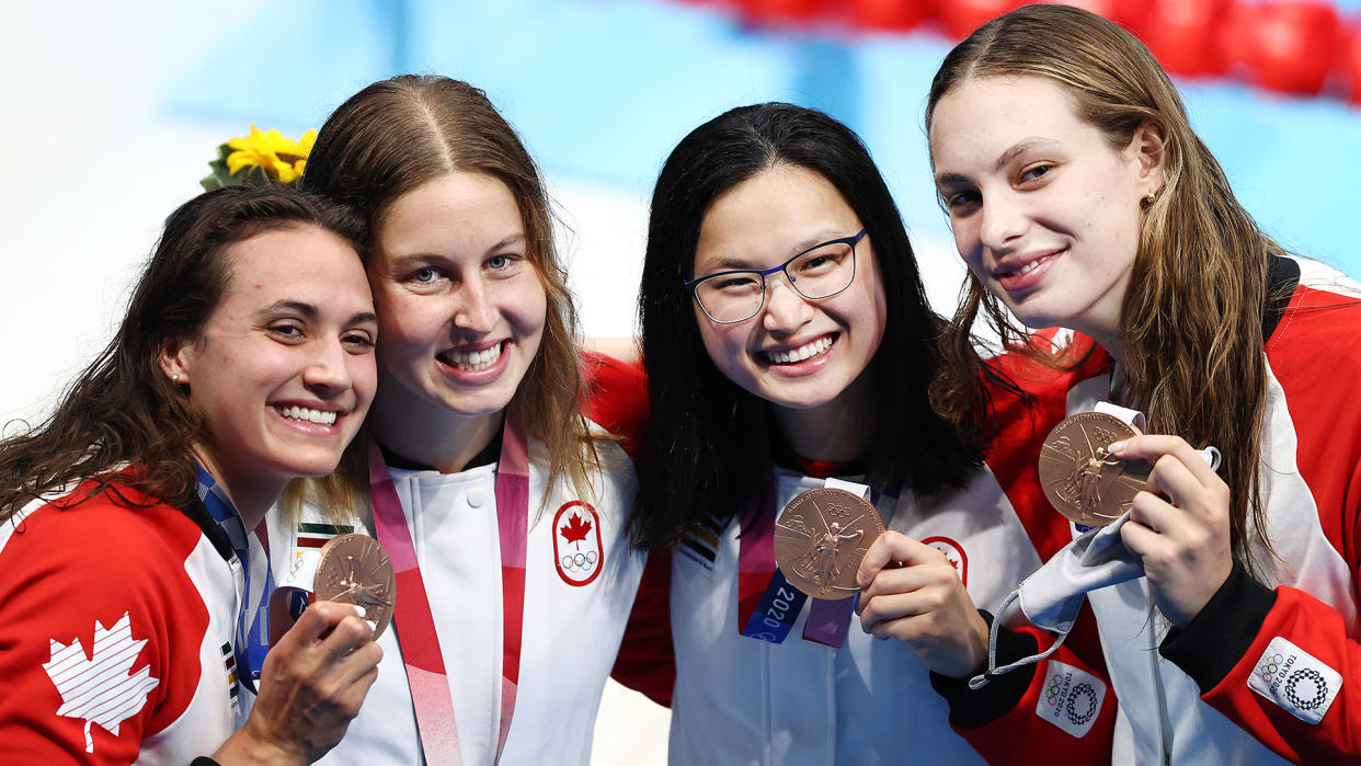 TOKYO, JAPAN - AUGUST 01: (L-R) Bronze medalist Kylie Masse, Sydney Pickrem, Margaret Macneil and Penny Oleksiak of Team Canada pose after the medal ceremony for the Women's 4 x 100m Medley Relay Final on day nine of the Tokyo 2020 Olympic Games at Tokyo Aquatics Centre on August 01, 2021 in Tokyo, Japan. (Photo by Maja Hitij/Getty Images)