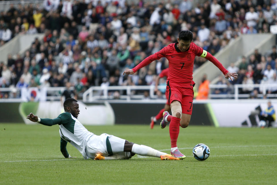 Saudi Arabia's Hassan Al Tambakti, left, challenges South Korea's Heung-min Son during their international friendly soccer match at St. James' Park, Newcastle upon Tyne, England, Tuesday, Sept. 12, 2023. (Will Matthews/PA via AP)