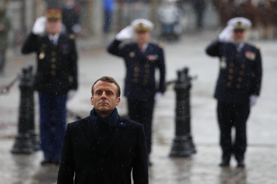 French President Emmanuel Macron stand at attention at the Arc de Triomphe during commemorations marking the 101st anniversary of the 1918 armistice, ending World War I, Monday Nov. 11, 2019 in Paris (AP Photo/Francois Mori, Pool)