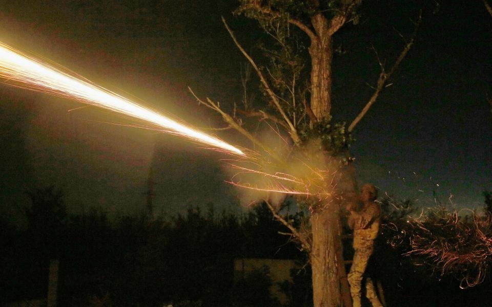 A Ukrainian solider opens fire during clashes near the frontline town of Avdiivka last week - Credit: VALERI KVIT/EPA