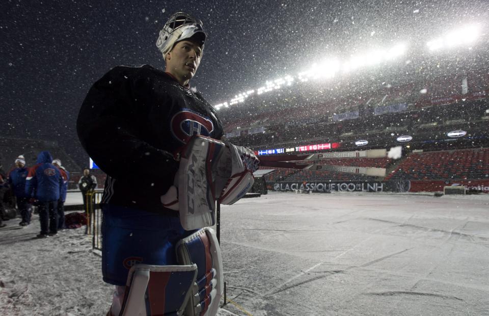 <p>Montreal Canadiens goalie Carey Price vacates the ice following an outdoor practice on a snowy Friday night in Ottawa. </p>