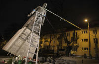 FILE - In this Thursday Feb. 21, 2019 file photo, activists in Poland pull down a statue of a prominent deceased priest, Father Henryk Jankowski, who allegedly abused minors sexually, in Gdansk, Poland. A documentary film with testimony by victims of clerical abuse in Poland is so harrowing that it has forced an unprecedented reckoning with the problem in one of Europe’s most deeply Catholic societies. (Bartek Sabela/Gazeta Wyborcza, via AP, File)