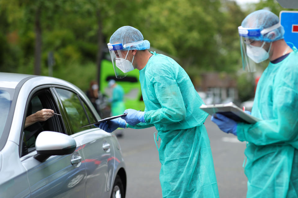 BONN, GERMANY - AUGUST 24:  An employee of the Bonn professional firefighters gives instructions to a man seeking a test for possible Covid-19 infection at a coronavirus testing station during the novel coronavirus pandemic on August 24, 2020 in Bonn, Germany. Coronavirus infection rates are climbing again in Germany, from an average of 400 new cases per day about few weeks ago to over 1,300 in the last days, according to the Robert Koch Institute. Authorities sees Germans returning from vacation abroad as a likely strong contributor to the uptick in infections.  (Photo by Andreas Rentz/2020 Getty Images)