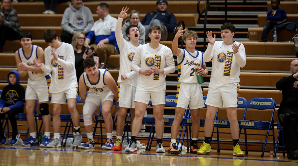 The Jefferson bench celebrates a 3 pointer during a 53-46 Jefferson victory over New Bosotn Huron Tuesday night.