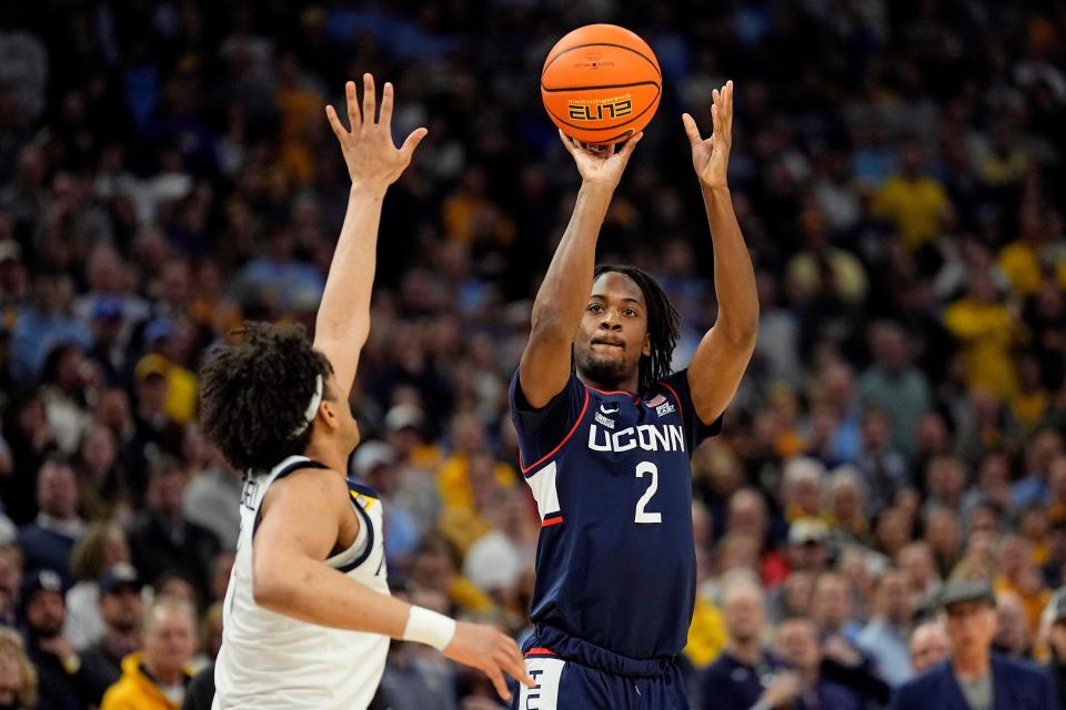 Connecticut Huskies guard Tristen Newton (2) shoots over Marquette Golden Eagles guard Stevie Mitchell (4) during the first half at Fiserv Forum.