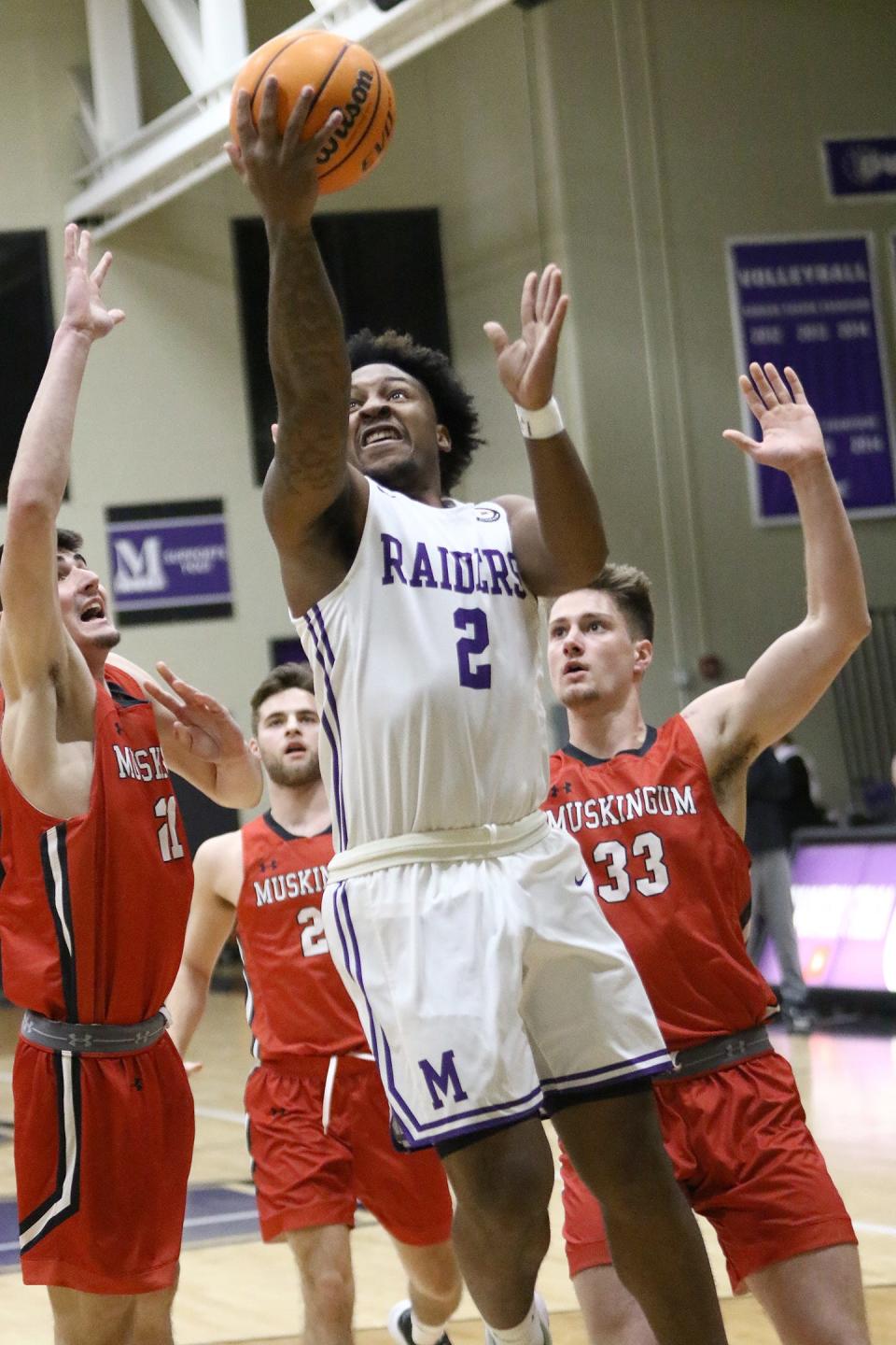 Mount Union's Collen Gurley puts up a shot between Muskingum defenders, Wednesday, Feb. 15, 2023.