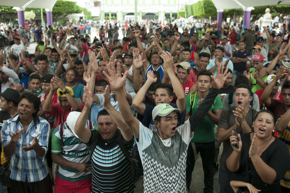 A group of Central American migrants gather in the central park of Ciudad Hidlago, Mexico, Saturday, Oct. 20, 2018. Mexican authorities for a second straight day refused mass entry to a caravan of Central American migrants held up at the border with Guatemala, but began accepting small groups for asylum processing and gave out some 45-day visitor permits that would theoretically allow recipients time to reach the United States. (AP Photo/Oliver de Ros)