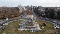 Workers install scaffolding as they prepare to remove the pedestal that once held the statue of Confederate General Robert E. Lee on Monument Avenue Monday Dec 6, 2021, in Richmond, Va. Virginia Gov. Ralph Northam ordered the pedestal removed and the land granted to the City of Richmond. (AP Photo/Steve Helber)