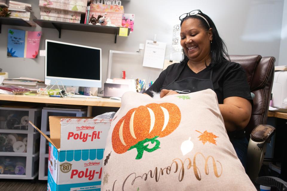 Finicky co-owner Janeen Bailey talks about the process of creating memorable and custom pieces to sell while she hand stuffs a fall-themed pillow.