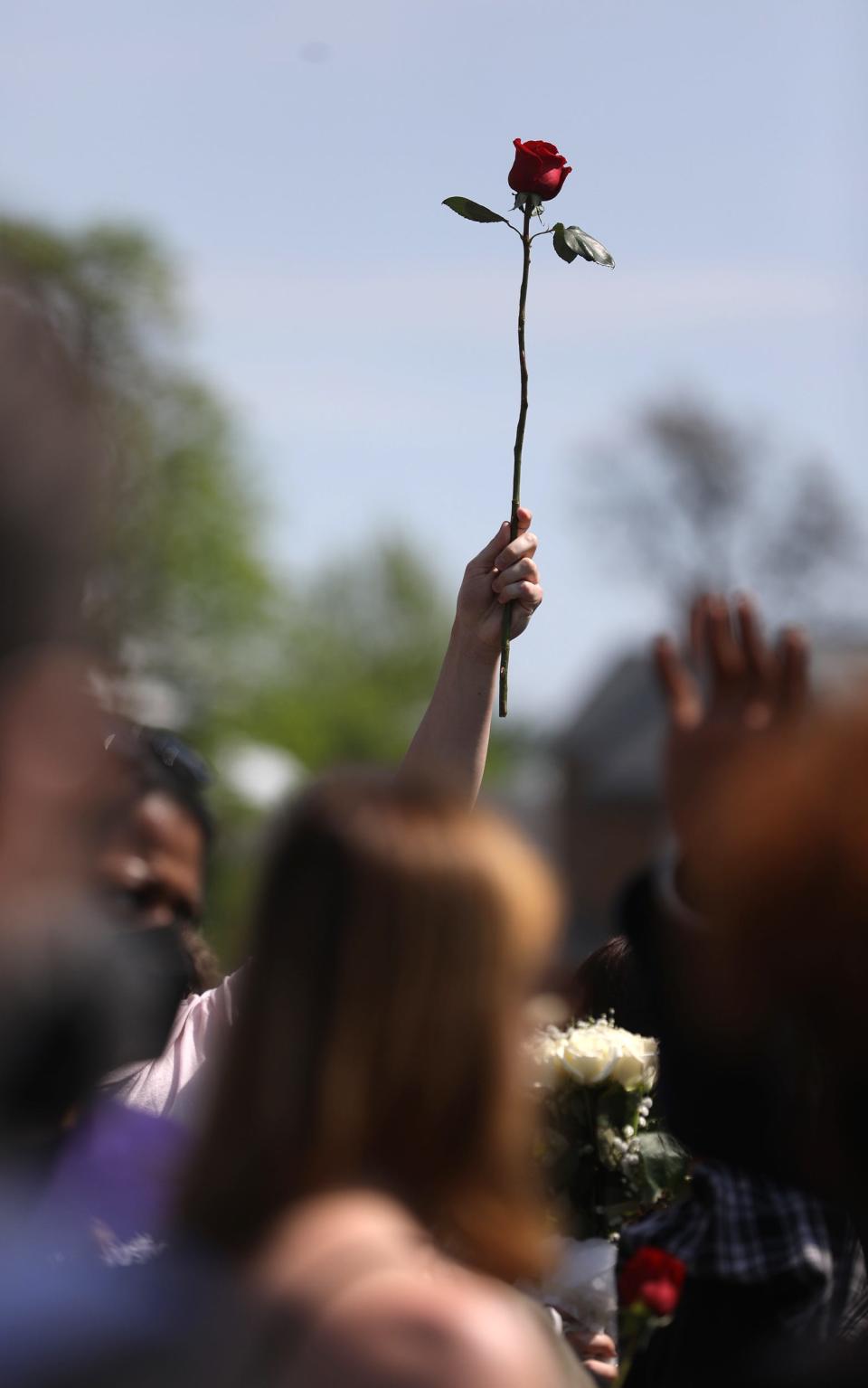 Family and community members marched around the neighborhood, holding up roses as they marched.  The group prayed in the street in front of the Tops Friendly Market on Jefferson Ave., in Buffalo, NY on May 15, 2022. Ten people were killed and three others injured in a shooting at the Buffalo grocery store on May 14, 2022.