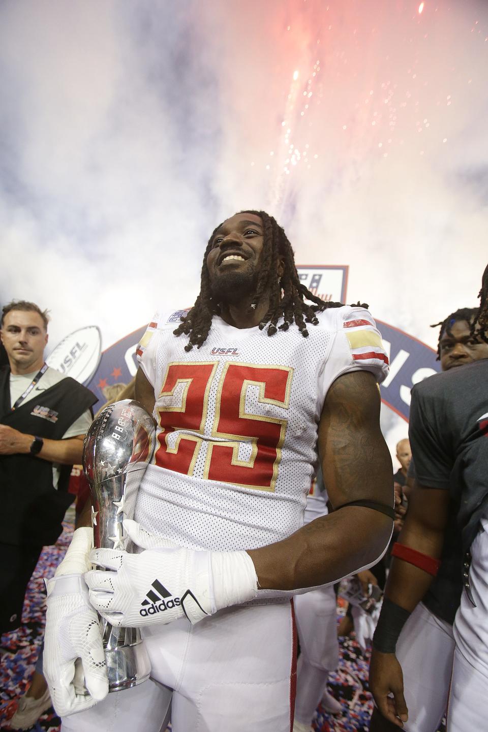 Stallions running back Bo Scarbrough celebrates his team's USFL championship win while holding the championship trophy after beating the Stars at Tom Benson Hall of Fame Stadium in Canton, Sunday, July 3, 2022.