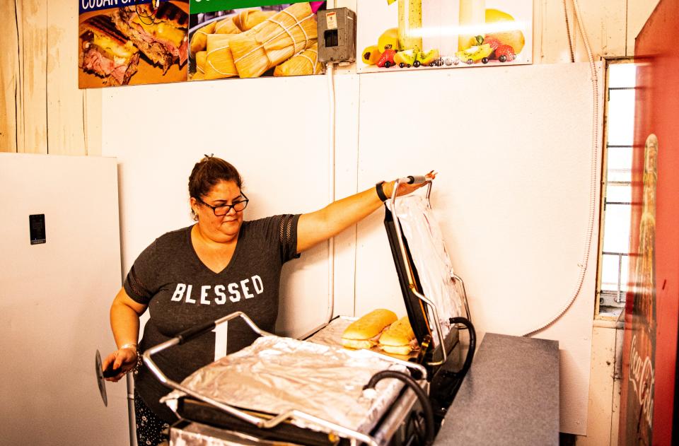 Janet Rodriguez prepares Cuban sandwiches at the Tropicaya Fresh Produce on Pine Island Road.