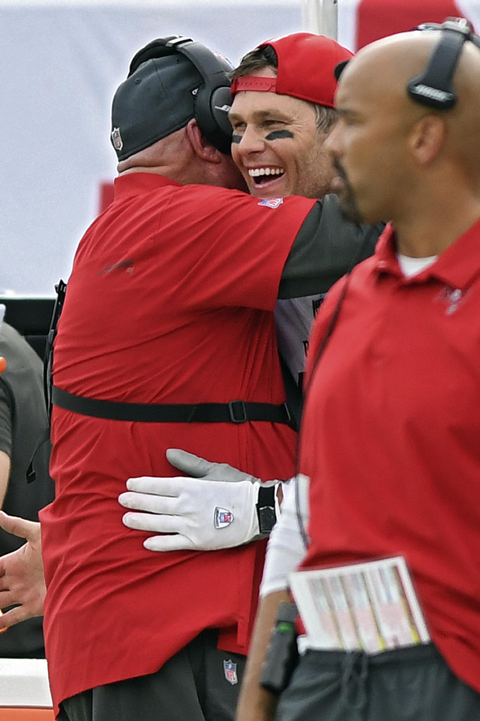 Tampa Bay Buccaneers head coach Bruce Arians, left, hugs quarterback Tom Brady (12) after Brady threw his 600th career touchdown pass against the Chicago Bears during the first half of an NFL football game Sunday, Oct. 24, 2021, in Tampa, Fla. (AP Photo/Jason Behnken)