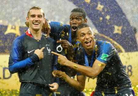 Soccer Football - World Cup - Final - France v Croatia - Luzhniki Stadium, Moscow, Russia - July 15, 2018 France's Antoine Griezmann, Paul Pogba and Kylian Mbappe celebrate after winning the World Cup REUTERS/Kai Pfaffenbach