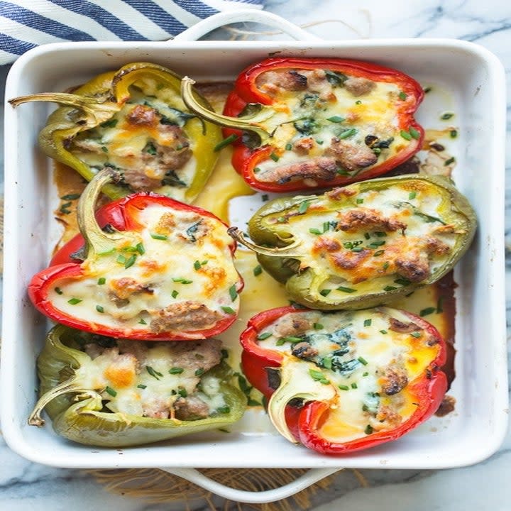 Egg stuffed peppers in a baking dish.