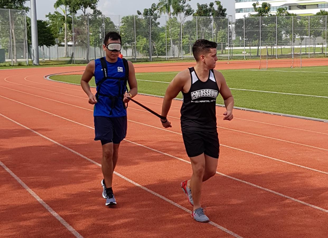 Andre Cherbonnier (left) running blindfolded with a guide runner during his training for the Standard Chartered Singapore Marathon 2018. (PHOTO: Andre Cherbonnier)