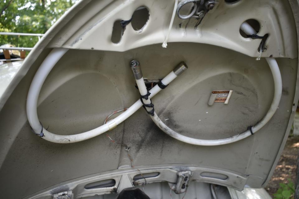 This simple fire-extinguishing system is standard under the hood of the 1955 Volkswagen Beetle.