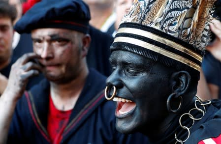"The Savage", a white performer in a blackface disguise, takes part in the festival Ducasse d'Ath in Ath