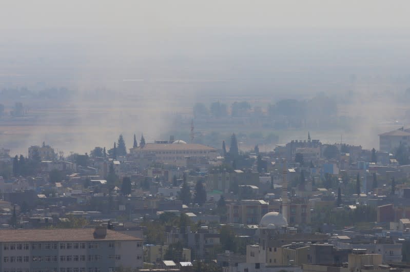 Smoke rises over the Syrian town of Ras al-Ain as seen from the Turkish border town of Ceylanpinar