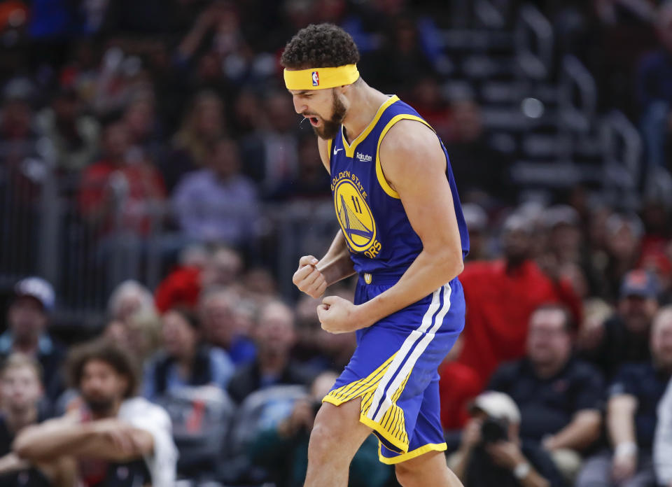 Golden State Warriors guard Klay Thompson celebrates after hitting his record 14th 3-pointer against the Chicago Bulls on Monday night. (AP Photo/Kamil Krzaczynski)