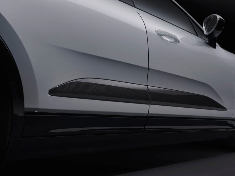 Detail shot of the carbon-fiber side blade on a white 2024 Porsche Macan EV