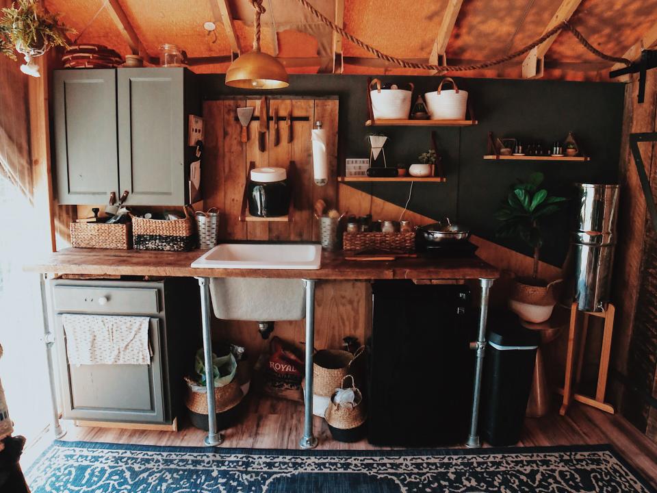 Zac Ruiz's kitchen in his tiny house with sink and green cabinetry