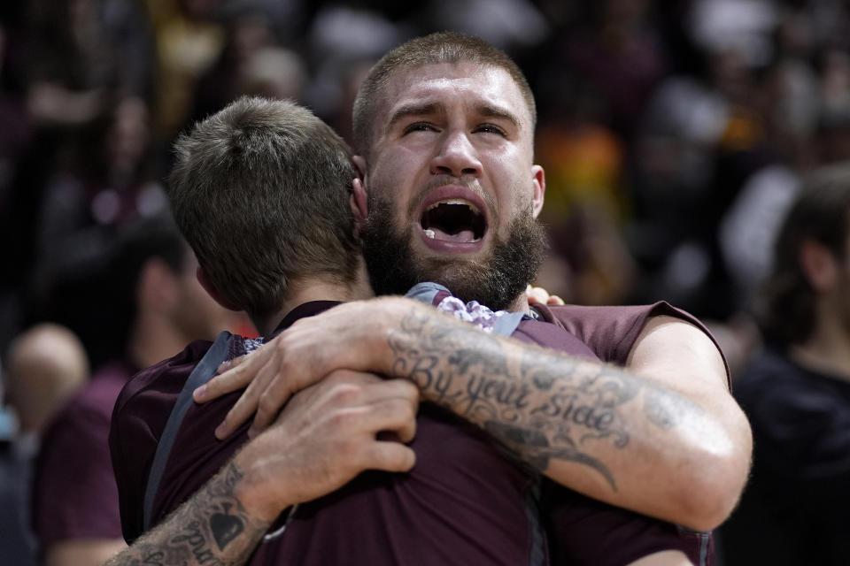 Freed-Hardeman forward Devin Tomlinson, back, celebrates with a teammate after their NAIA men's national championship college basketball game against Langston, Tuesday, March 26, 2024, in Kansas City, Mo. Freed-Hardeman won 71-67. (AP Photo/Charlie Riedel)