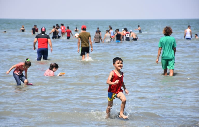 Iraqis swim and play on Lake Habbaniyah on August 22, 2018