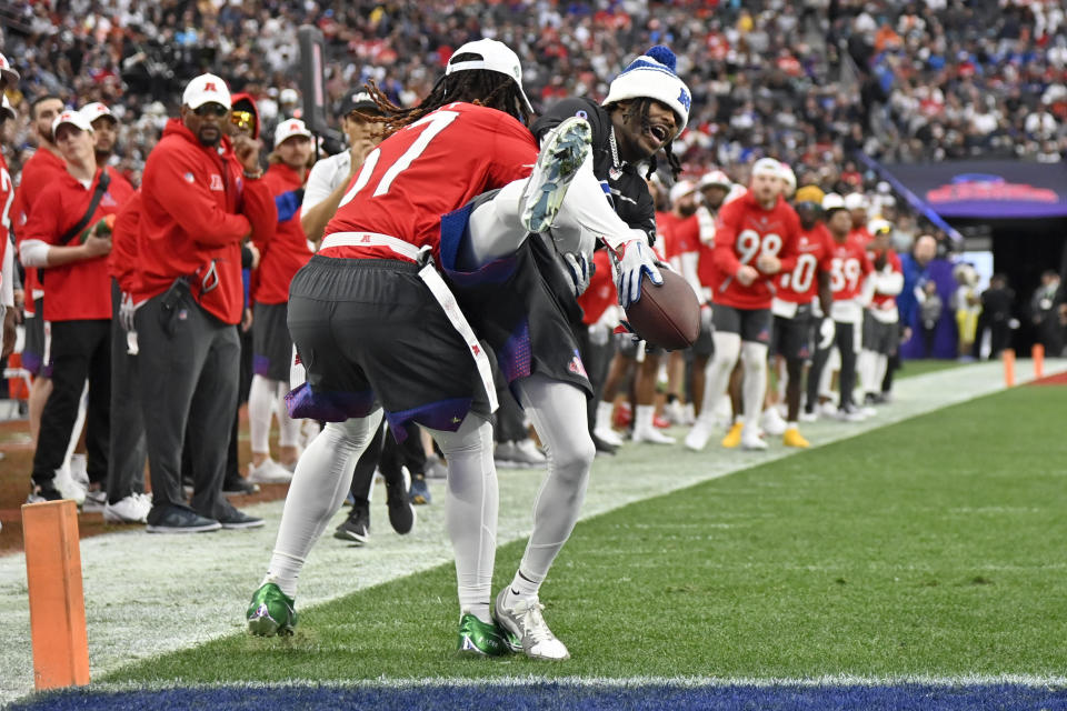 NFC return specialist KaVontae Turpin of the Dallas Cowboys is stopped by AFC middle linebacker C.J. Mosley of the New York Jets during the flag football event at the NFL Pro Bowl, Sunday, Feb. 5, 2023, in Las Vegas. (AP Photo/David Becker)