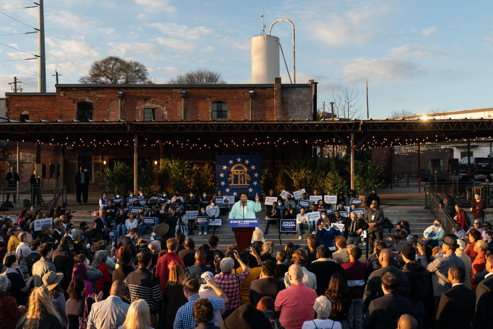 Stacey Abrams speaks to a crowd at a campaign event.