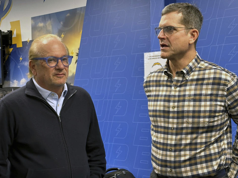 Los Angeles Chargers owner Dean Spanos, left, and coach Jim Harbaugh talk after a news conference introducing Joe Hortiz as general manager, Tuesday, Feb. 6, 2024 at the Chargers Hoag Performance Center in Costa Mesa, Calif. Hortiz comes to the Chargers after 26 years with the Baltimore Ravens, recently as the director of player personnel. (AP Photo/Joe Reedy)