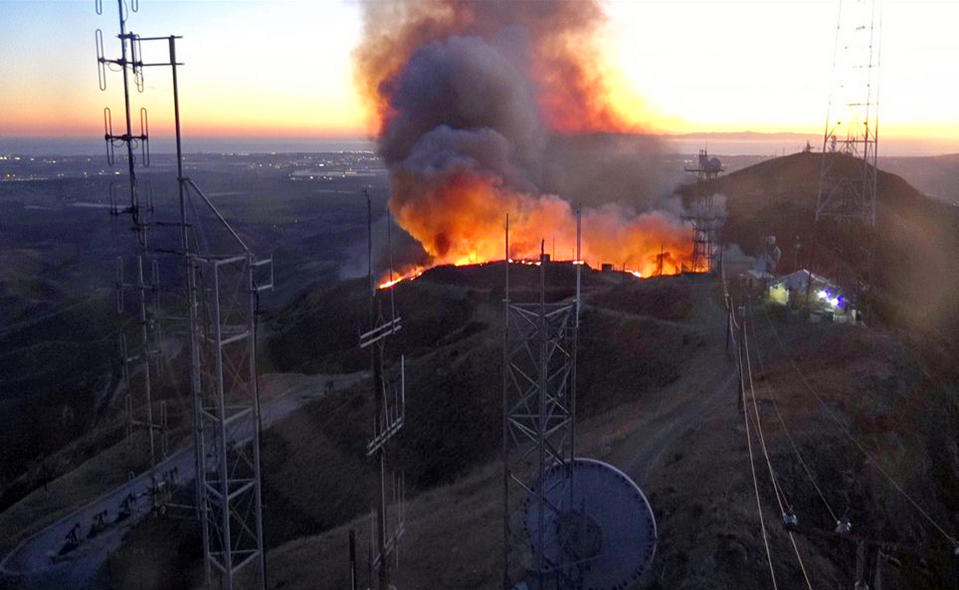 This remote-camera photo posted on the Ventura County Fire Department's Twitter page shows the beginning of the Maria fire at an antenna farm atop South Mountain near Santa Paula, Calif., Thursday evening, Oct. 31, 2019. (Ventura County Fire Department via AP)