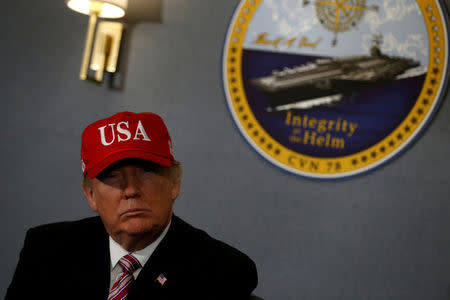 FILE PHOTO: U.S. President Donald Trump gets a briefing before he tours the pre-commissioned U.S. Navy aircraft carrier Gerald R. Ford at Huntington Ingalls Newport News Shipbuilding facilities in Newport News, Virginia, U.S. March 2, 2017. REUTERS/Jonathan Ernst/File Photo