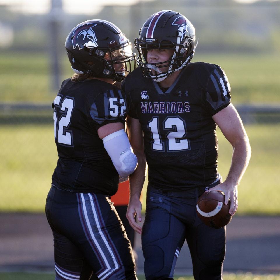 Harvest Prep quarterback Aidan Rogers (12) celebrates with offensive lineman Preston Ross after scoring a touchdown last season.