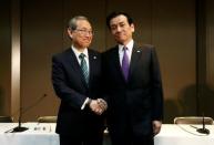 Toshiba Corp incoming President and chief executive Satoshi Tsunakawa (L) and incoming chairman Shigenori Shiga pose for a photograph at a news conference at the company headquarters in Tokyo, Japan May 6, 2016. REUTERS/Issei Kato