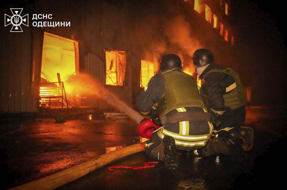 In this photo provided by the Ukrainian Emergency Service, emergency services personnel work to extinguish a fire following a Russian attack in Odesa, Ukraine, Wednesday, May 1, 2024. (Ukrainian Emergency Service via AP)